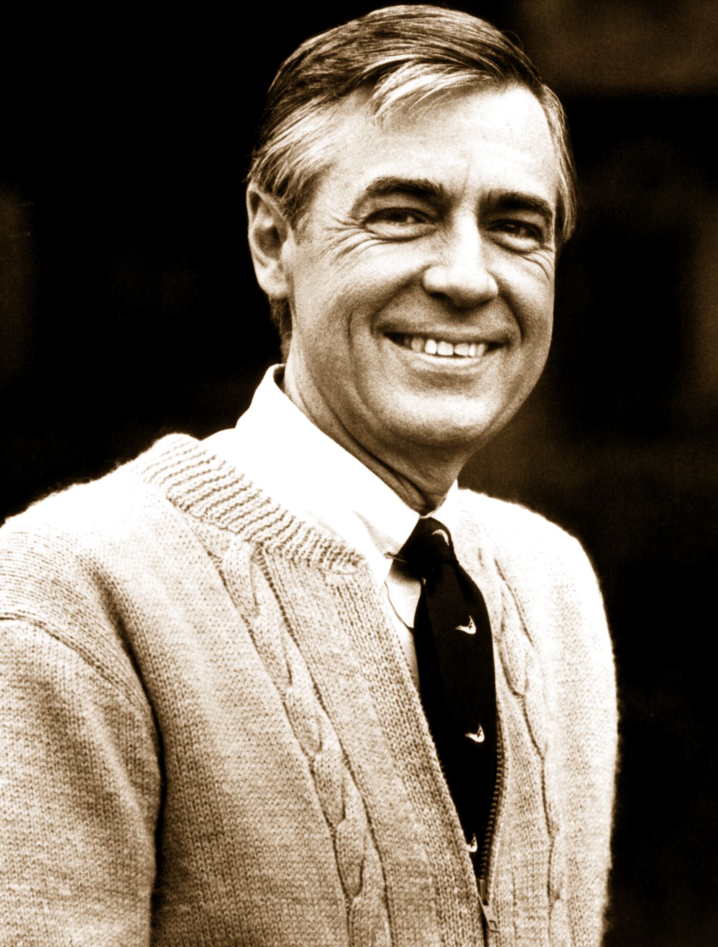 Fred Rogers, smiling, in his cardigan